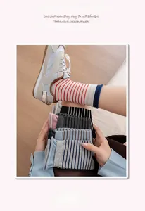 Detail of striped cotton crew socks featuring high-elasticity wide ribbed cuffs and varied colors
