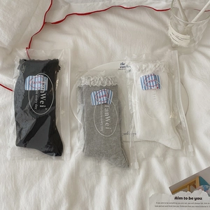 Set of three ribbed crew socks in black, white and grey with delicate lace trim edges