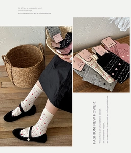 Detailed knit patterns and heart motifs on assorted color Fair Isle crew socks