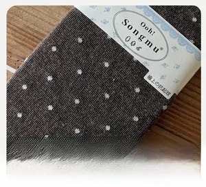 Detail of dark brown polka dot cotton socks with ribbed texture and reinforced heel