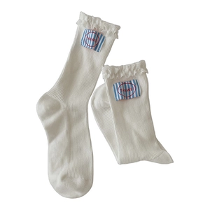 White rib-knit crew socks with delicate lace trim and striped letter patch detail