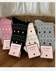 Set of four cotton knit crew socks with Nordic heart patterns in various colors