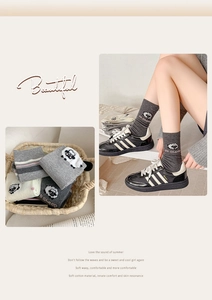 Close-up of knit crew socks featuring cute 3D sheep patches and soft cotton texture