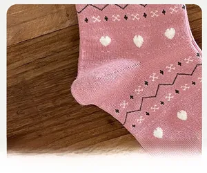 Macro shot of reinforced toe detail on pink Fair Isle knit socks with heart patterns