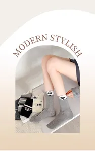 Detail of cute fluffy sheep embroidery on gray mid-calf socks with striped patterns