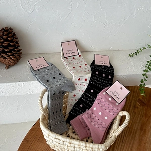Set of four vintage Fair Isle crew socks in various colors with geometric heart patterns