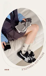 Detailed view of combed cotton crew socks featuring cute sheep patterns and striped designs