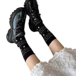 Fair Isle pattern mid-calf socks with black Mary Jane shoes and pink heart motifs