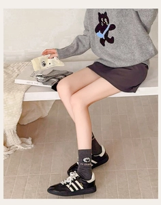 Close-up of cute cartoon sheep patterns and Hi Sheep lettering on cotton mid-calf socks