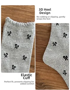 Detail of grey ribbed cotton socks featuring black bow prints and elastic cuffs