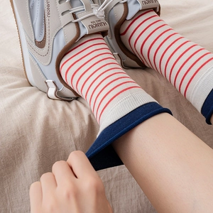 Classic red and white striped cotton crew socks with dark blue rolled edges for women