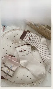 Detail of cute dog embroidery and striped patterns on Japanese style crew socks