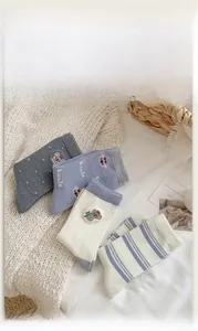 Detail view of four pairs of warm wool blend socks with cute koala embroidery and stripes