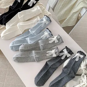 Ballet style crew socks with pearl bow detail and ruffled edges in five soft colors