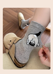 Detail showing high-stretch grey cotton sock with 3D white pom-pom cat tail decoration