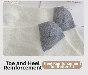 Close-up of reinforced heel detail on wool socks featuring beige and gray knit texture