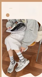 Detail of striped cotton crew socks shown in a cozy lifestyle setting with multiple colors