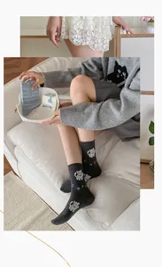 Detailed view of women's cotton crew socks featuring cute flocked cat patterns and stripes