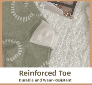 Detailed view of light green knit socks with reinforced toe and soft texture