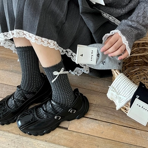Grey crew socks with white polka dots and delicate side bow decorations for women