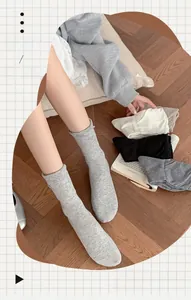 Detail of ribbed knit cotton blend mid-calf socks in various neutral colors for women