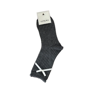 Dark gray knitted mid-calf socks with white polka dots and a silk bow decoration