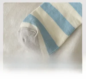 Detail of flat-stitched toe and blue-white striped knit fabric of the cotton sock