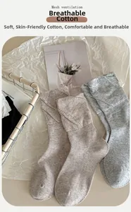 Detail of grey cotton socks showing breathable mesh ventilation and soft texture