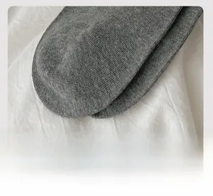 Detailed close-up of dark grey knitted socks showing seamless flat toe seam craftsmanship