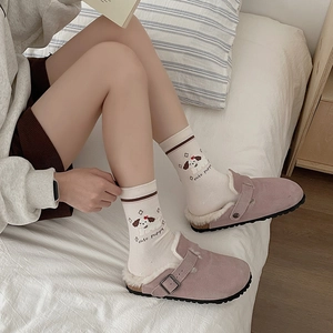 Cozy pink suede shearling-lined slippers with buckle strap and non-slip rubber sole