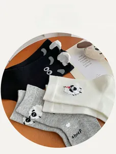 Detailed set of three mid-calf socks in black white and grey with 3D sheep embroidery