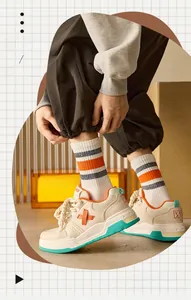 Detailed close-up of breathable striped crew socks with orange and black accents