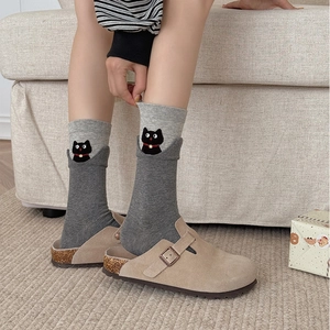 Cozy gray cotton crew socks with cartoon cat pattern paired with stylish suede clogs