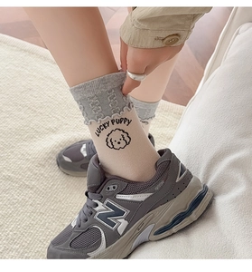 Detail of cute puppy pattern and ruffled cuff on these beige cotton knit socks