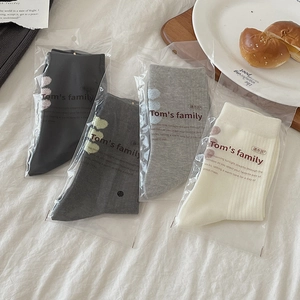 Mid-calf socks set in grey and white with plush heart detail on white fabric