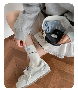Detail of cute cat embroidery and striped patterns on cotton mid-calf socks set
