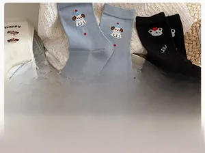 Detailed flat lay of soft cotton socks featuring cute cartoon dog prints and heart patterns