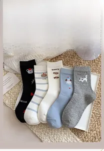 Flat lay of five pairs of cartoon animal embroidery socks in various colors on a tray