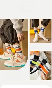 Detail of striped cotton crew socks for men paired with stylish chunky sneakers