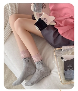Detail of ruffled edges and cute puppy embroidery on colorful mid-calf cotton socks