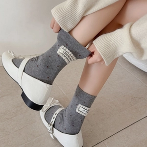Fashionable dark grey mid-calf socks with brown polka dots and lace label detailing