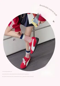 Detailed view of breathable red and white striped cotton socks with dark blue cuffs