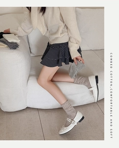Detailed texture of combed cotton ribbed socks in neutral grey and white colors