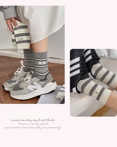 Close-up of Japanese style striped crew socks with unique egg label and cotton texture