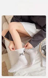 Elastic white Lolita crew socks featuring a grey plaid bow and lace trim detail