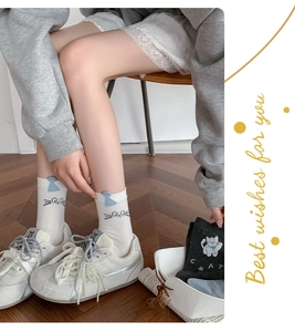 Detailed view of women's mid-calf socks with cute flocked cat patterns and cat embroidery