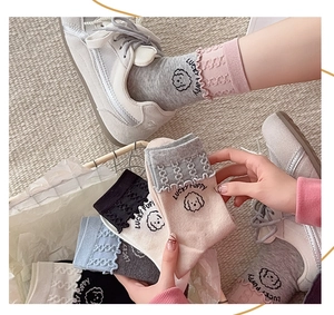 Detailed view of ruffle edge socks with Lucky Puppy cartoon motif and knitting texture
