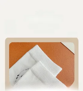 Close-up of soft ribbed cuffs on white 3D lamb socks showing high elasticity and texture
