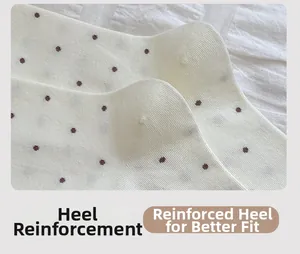 Detail showing the reinforced heel of a white polka dot cotton sock for better fit