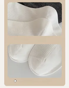 Detailed macro view of white ribbed cotton socks showing seamless toe and 3D heel construction